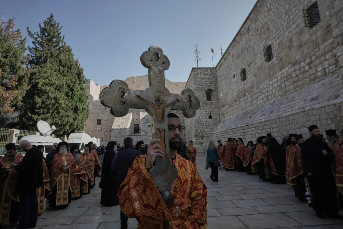Clergy prepare for the arrival of Greek Orthodox Patriarch of Jerusalem Theophilos III to the Church of the Nativity, traditionally believed to be the birthplace of Jesus Christ, to celebrate Christmas according to the Eastern Orthodox calendar, in Bethlehem in the occupied West Bank.