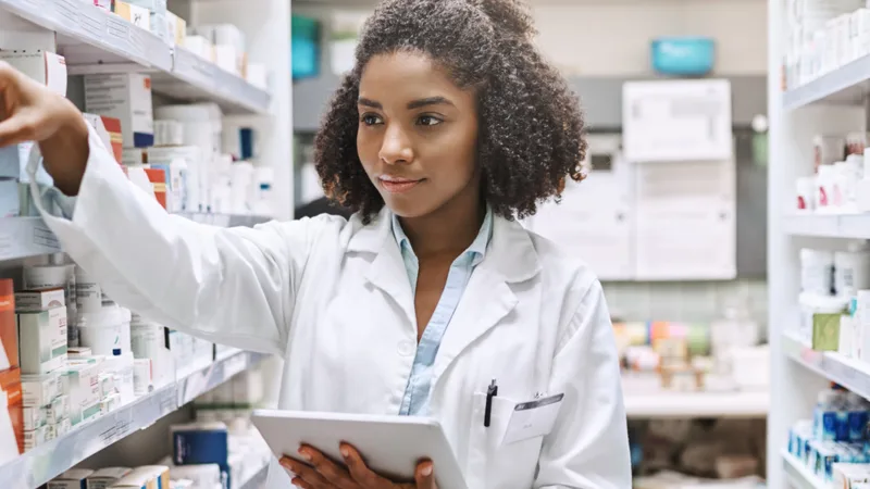 Pharmaceutical manufacturing pharmacist supervising tablet production line in Ogun State