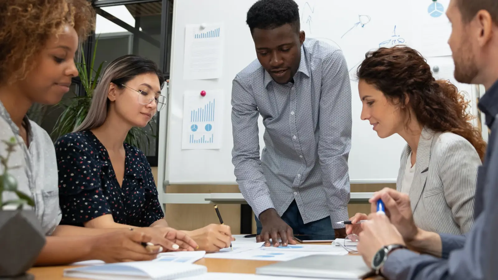 Procurement intern reviewing purchase orders in corporate office