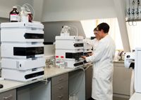 Pharmaceutical quality assurance manager inspecting sterile infusion production line