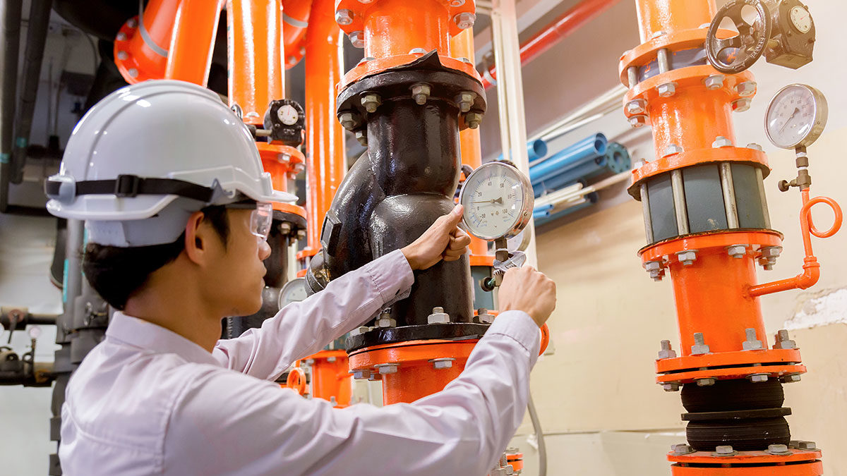 Maintenance manager inspecting building equipment in a facility