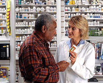 Pharmacist job in Abuja attending to customers inside a pharmacy