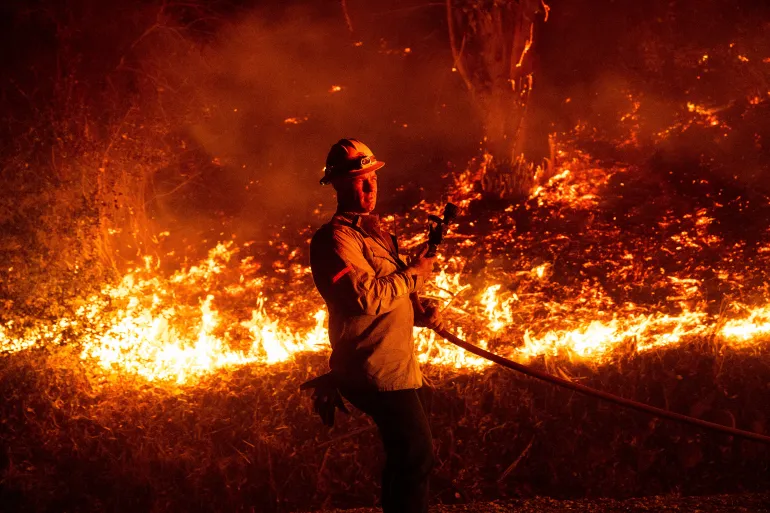 Thousands in California evacuated as wildfires raze homes near Los Angeles