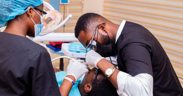 Falash Dental Clinic Dentist Job Abuja attending to a patient
