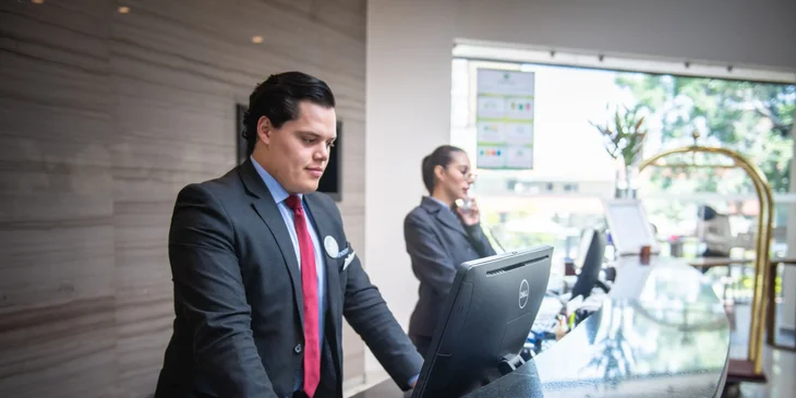 Front Desk Manager Job Abuja welcoming visitors at a corporate office