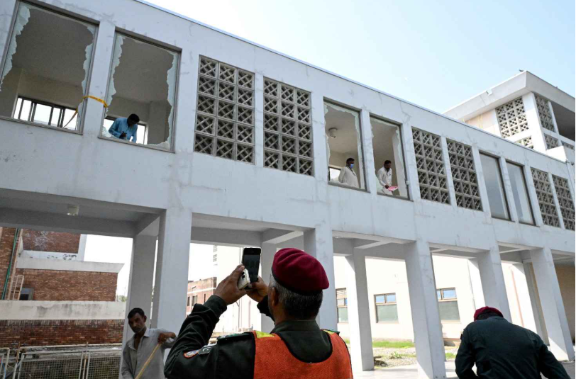 Parents mourn outside PIMS Hospital in Islamabad after a fire in the Mother and Child Health Ward killed 14 newborns.