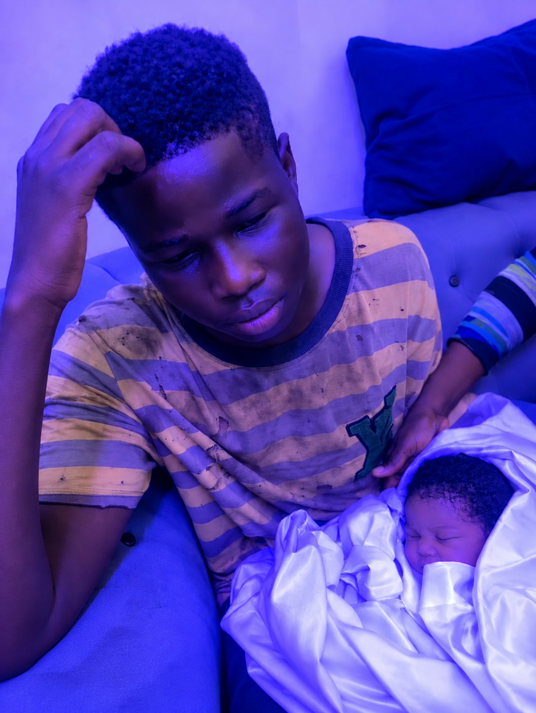 Young Nigerian dad newborn responsibility while holding baby