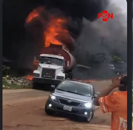 Iwo burning fuel tanker driver moves a burning tanker away from nearby buildings.