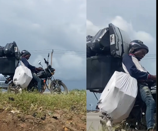 Lagos dispatch rider dozes on motorcycle while waiting for a delivery.